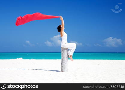 happy woman with red sarong on the beach