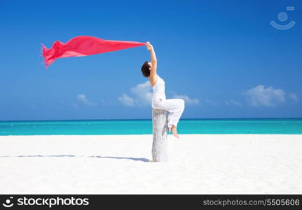 happy woman with red sarong on the beach