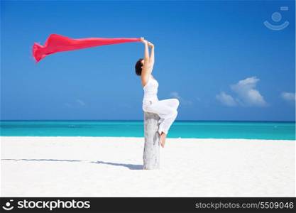 happy woman with red sarong on the beach