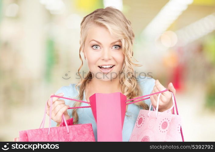 happy woman with shopping bags at the mall