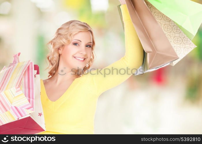 happy woman with shopping bags at the mall