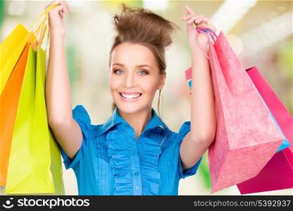 happy woman with shopping bags at the mall