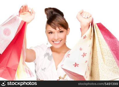 happy woman with shopping bags over white