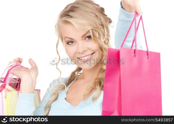 happy woman with shopping bags over white