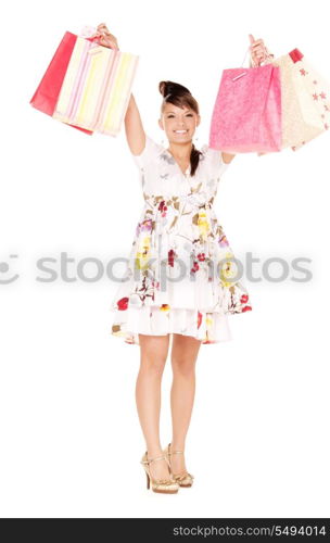 happy woman with shopping bags over white