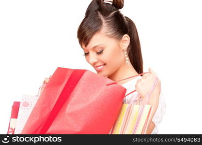 happy woman with shopping bags over white