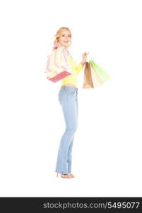 happy woman with shopping bags over white