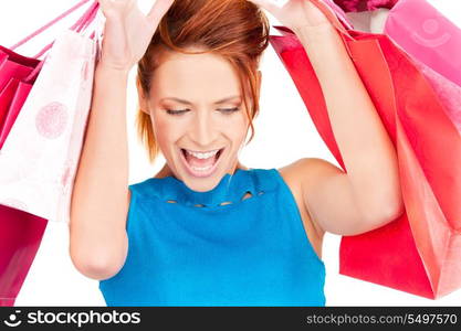 happy woman with shopping bags over white