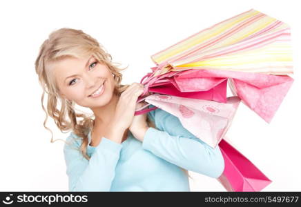 happy woman with shopping bags over white