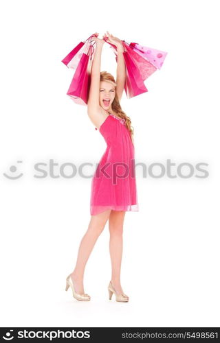 happy woman with shopping bags over white