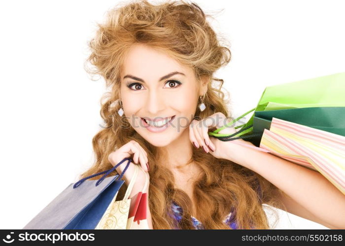 happy woman with shopping bags over white