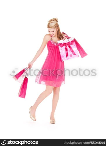 happy woman with shopping bags over white