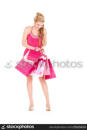 happy woman with shopping bags over white