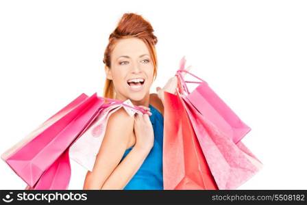 happy woman with shopping bags over white