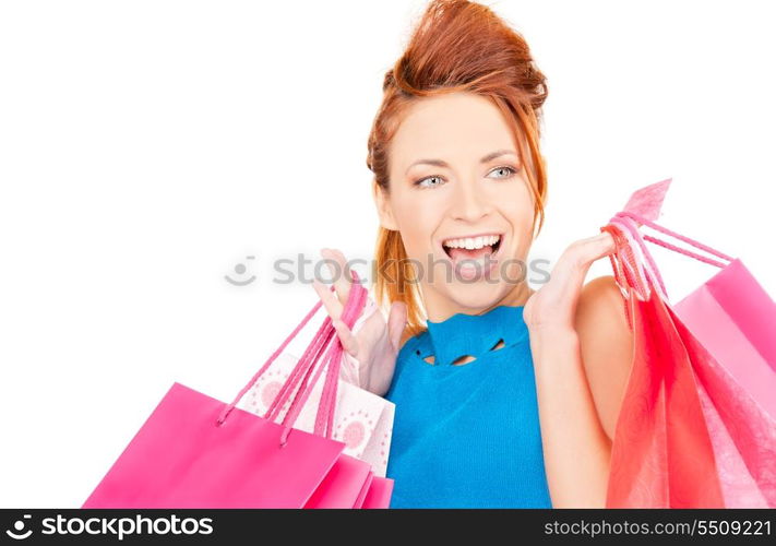 happy woman with shopping bags over white