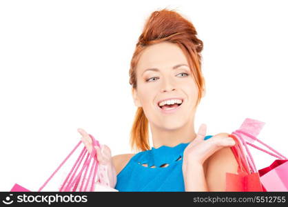 happy woman with shopping bags over white