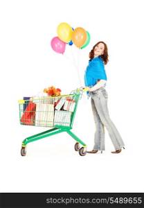 happy woman with shopping cart and balloons over white