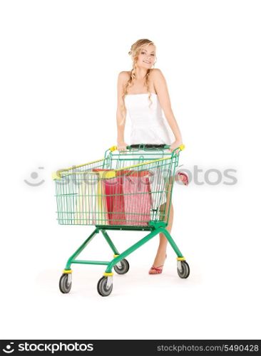happy woman with shopping cart over white