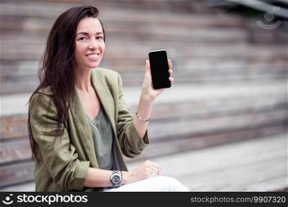 Happy woman with smartphone outdoors in the park. Happy woman with smartphone outdoors in the city