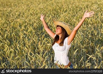 Happy woman with straw hat enjoy sun in corn field