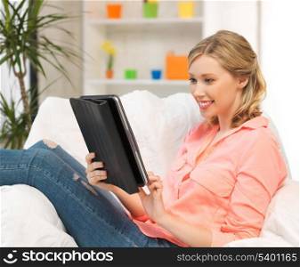 happy woman with tablet pc computer or touchpad indoors