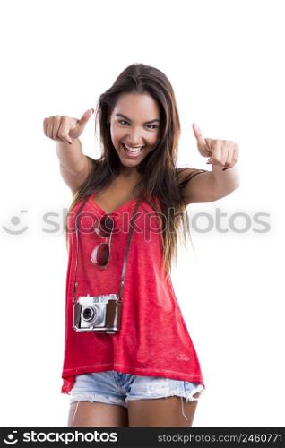 Happy woman with thumbs up and posing with a old vintage camera, isolated on white background