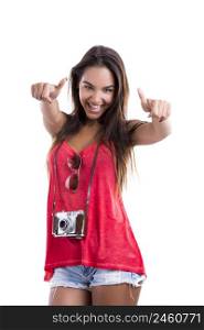 Happy woman with thumbs up and posing with a old vintage camera, isolated on white background