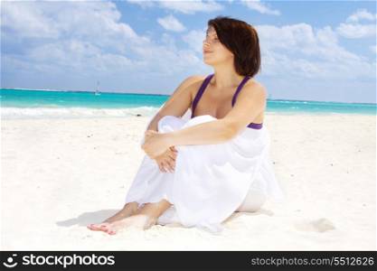 happy woman with white sarong on the beach