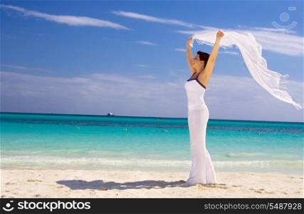happy woman with white sarong on the beach. happy woman with white sarong