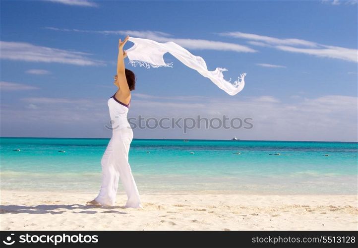 happy woman with white sarong on the beach. happy woman with white sarong