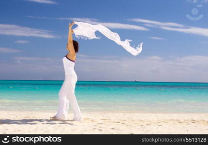 happy woman with white sarong on the beach. happy woman with white sarong