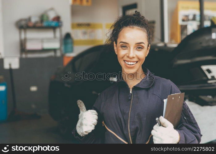 happy woman worker working for car auto service trumbs up smiling