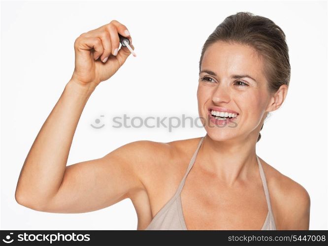 Happy woman writing in air with lip gloss