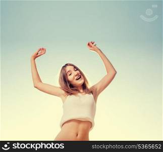 Happy women against clear sky. Blonde teenager girl jumping happy with the blue sky in the background