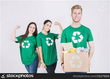 happy women flexing their muscles man holding recycle items cardboard box