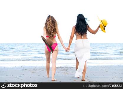 Happy women friends are on vacation at tropical sand beach in summer.. Happy women go sunbathing at sand beach in summer.