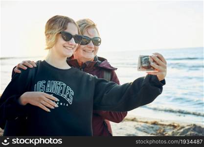 Happy women making video call on smartphone during trip on summer vacation. Taking selfie photos