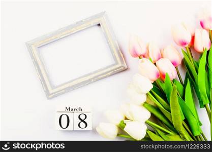 Happy Women&rsquo;s Day, Mother&rsquo;s Day and Valentine&rsquo;s Day concept. top view flat lay Tulip flower and photo frame on white background, copy space for your text