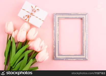 Happy Women&rsquo;s Day, Mother&rsquo;s Day concept. top view flat lay photo frame and Tulip flower on pink background, copy space for your text