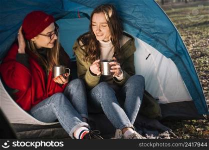 happy women sitting tent