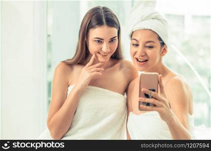 Happy women takes selfie photo with mobile phone in luxury spa after aromatherapy massage. Luxury wellness lifestyle and social media information sharing concept.