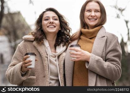 happy women walking outdoors together