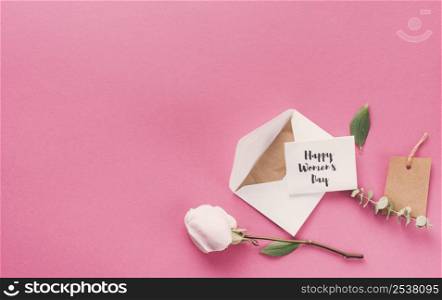 happy womens day inscription with envelope flower table