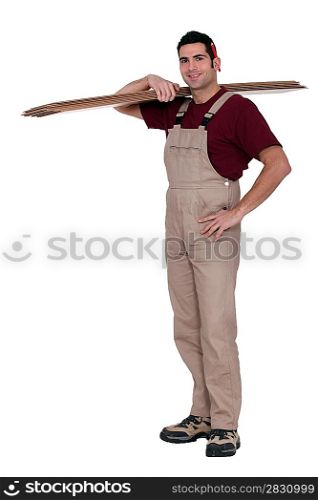 Happy woodworker standing on white background