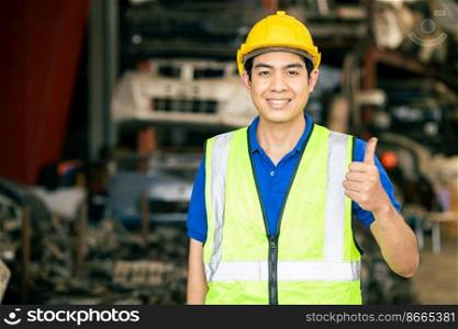 Happy worker Asian male man with safety suit work in engineering factory hand thumbs up sign