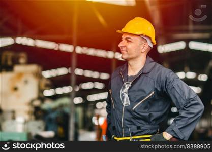 Happy worker, portrait smile handsome labor with safety suit tools belt and radio service man in factory.