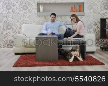 happy youg family relaxing in modern livingroom at home