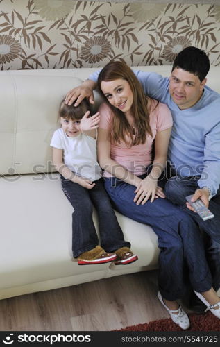 happy youg family relaxing in modern livingroom at home