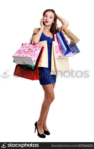 Happy young adult woman with colored bags