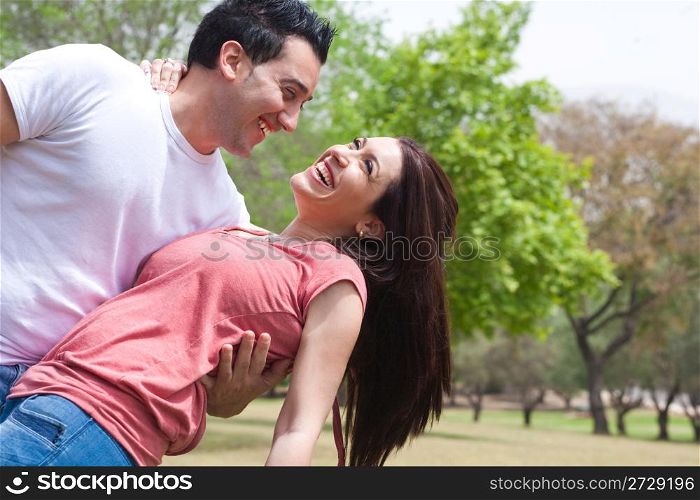 Happy young adults in love in the park,outdoors